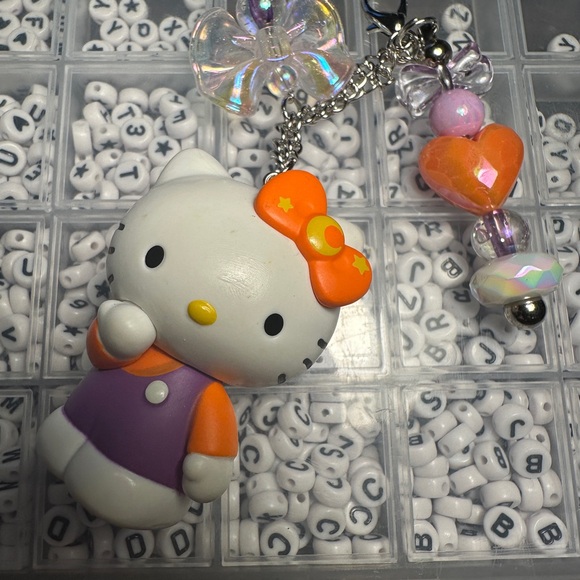 Cute Hello Kitty Character Keychains with Purple and Orange Accents - Picture 3 of 7